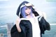 A woman with blue hair wearing a penguin costume.